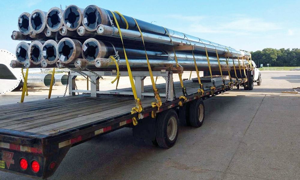 pipes transported on a step deck trailer