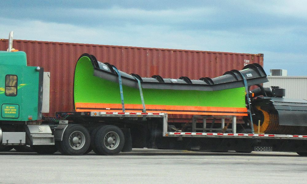prefabricated structure transported on a step deck trailer